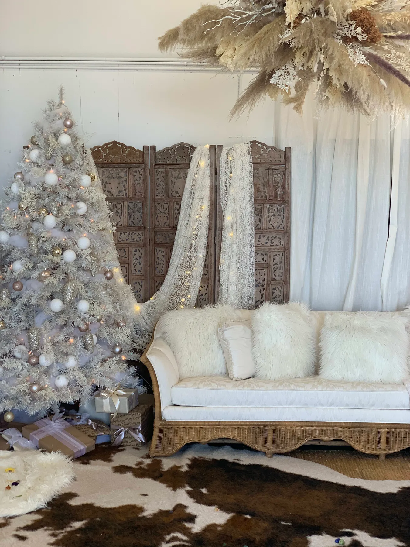 A boho white couch adorned next to a Christmas tree for a photo shoot by Elizabeth Persico in Minneapolis, MN