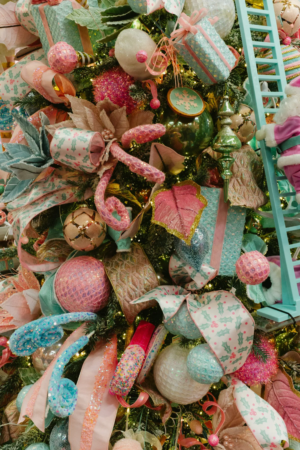 A christmas tree decorated with pink and blue ornaments
