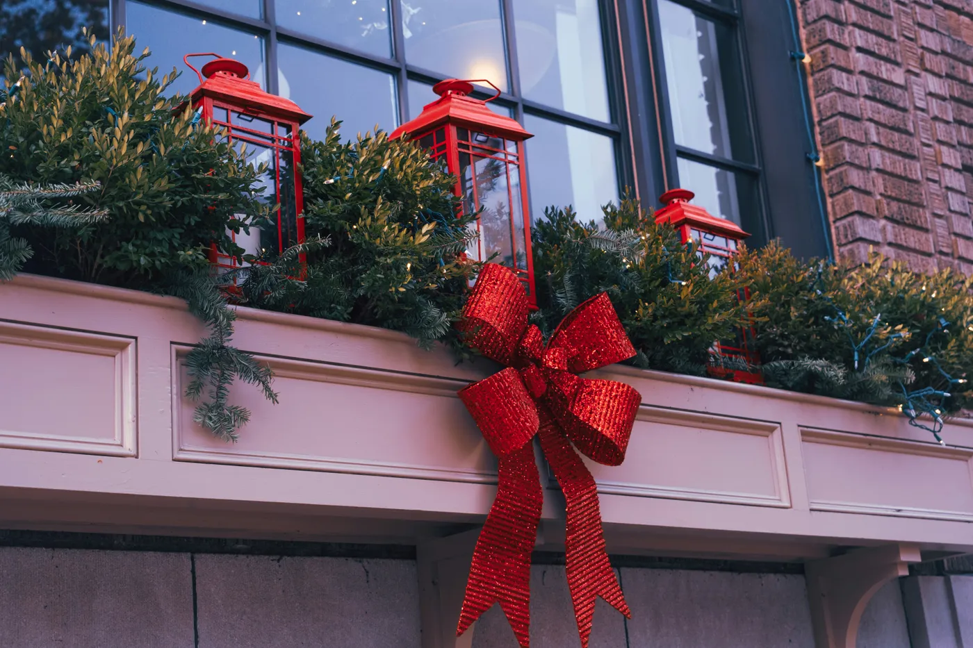 a red bow is tied to a window sill