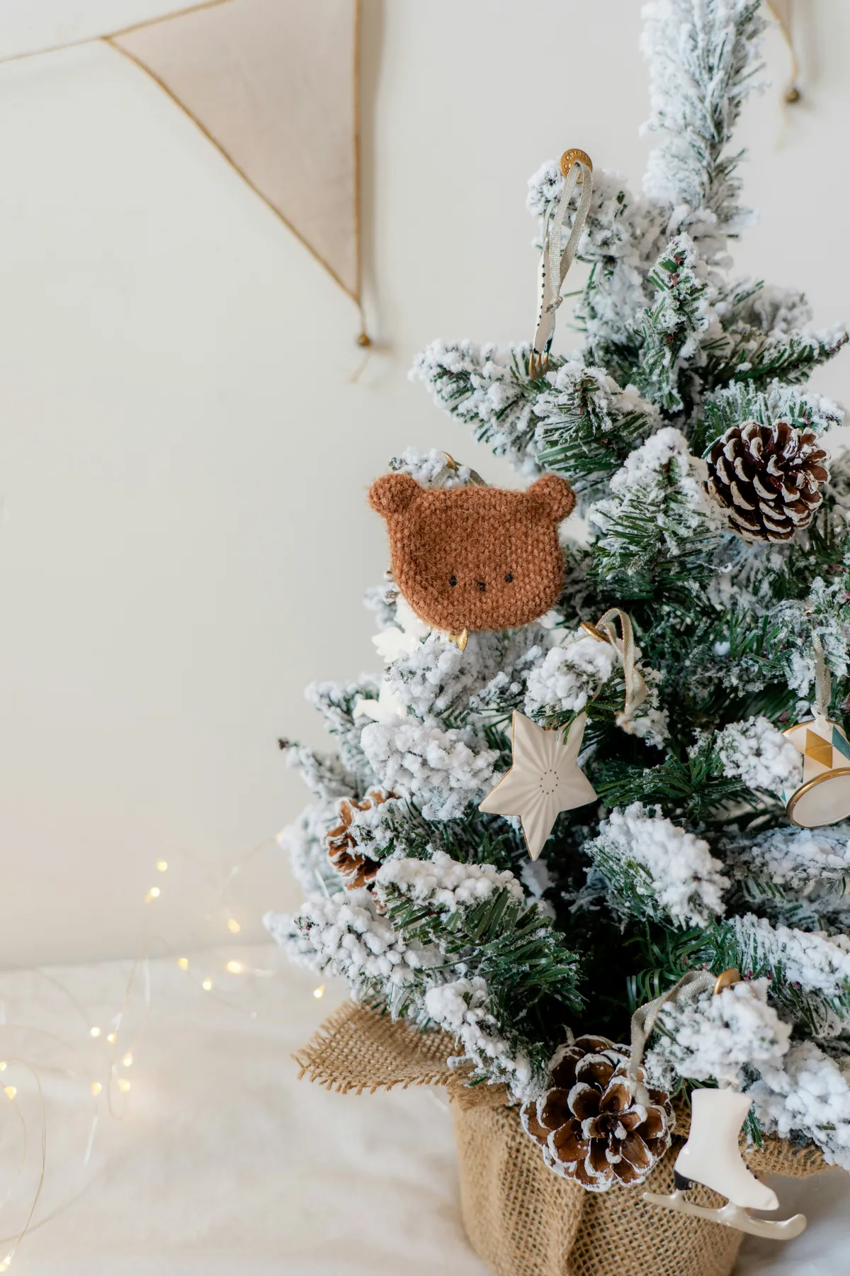 A small christmas tree with a teddy bear decoration