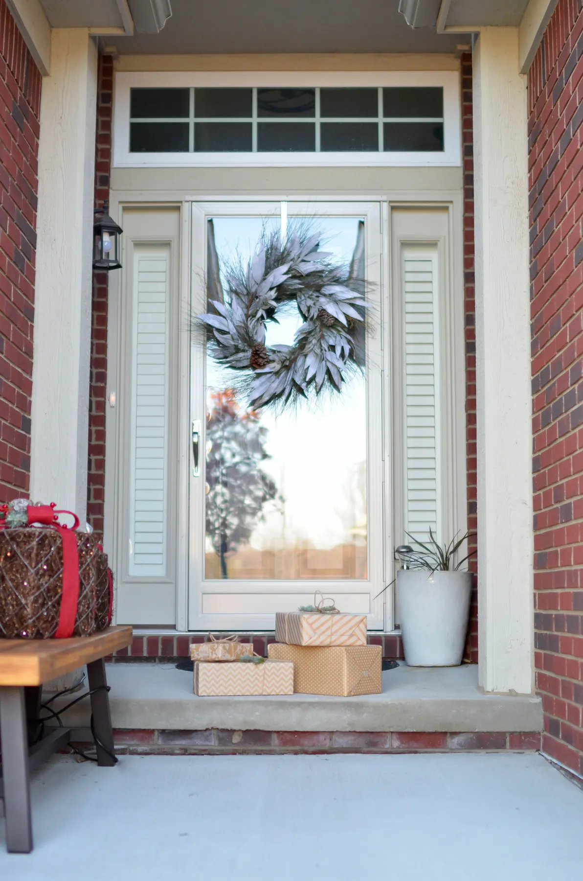 An inviting front door adorned with a holiday wreath and wrapped gifts, perfect for the festive season.