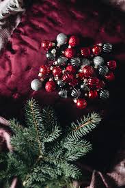 Burgundy Christmas Still Life with Baubles, Greenery and Warm Lights. Ideal  for holidays and decor projects. Free for commercial use.