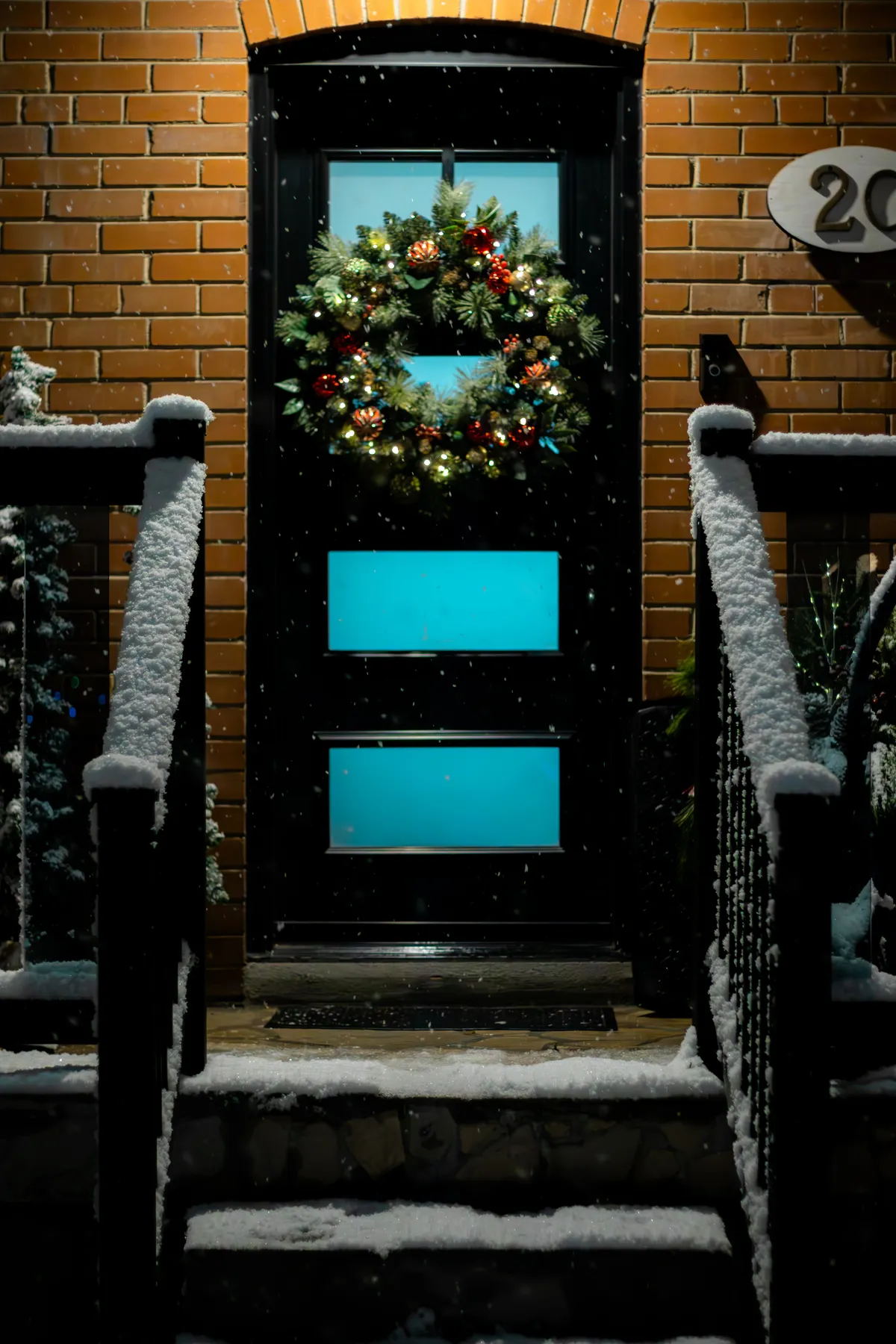 Celebrate the holiday season with a beautifully lit Christmas wreath in snowy Toronto.