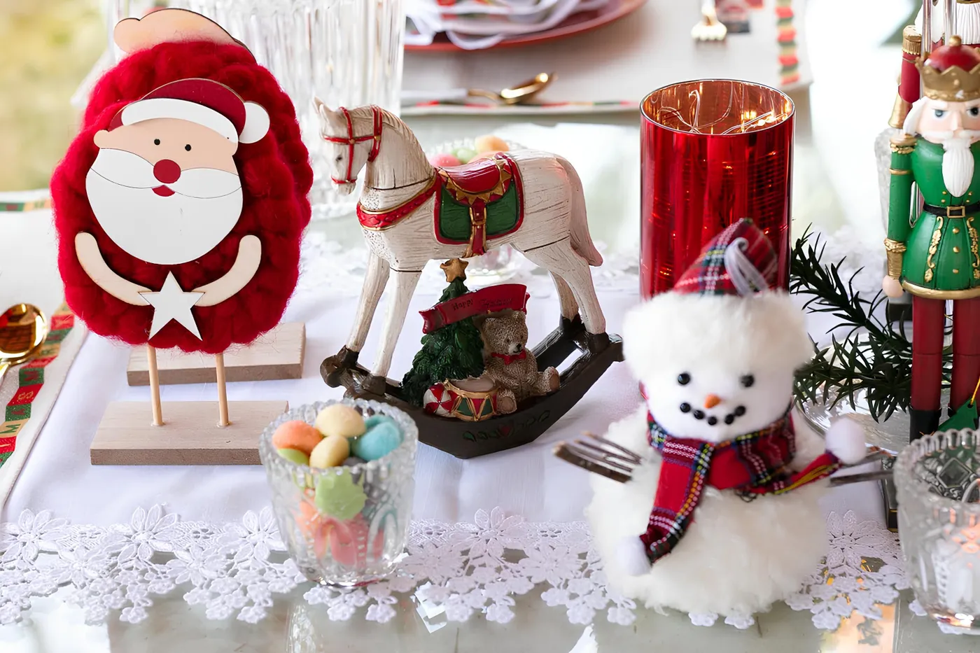 Charming Christmas tabletop with Santa, snowman, and holiday decor.