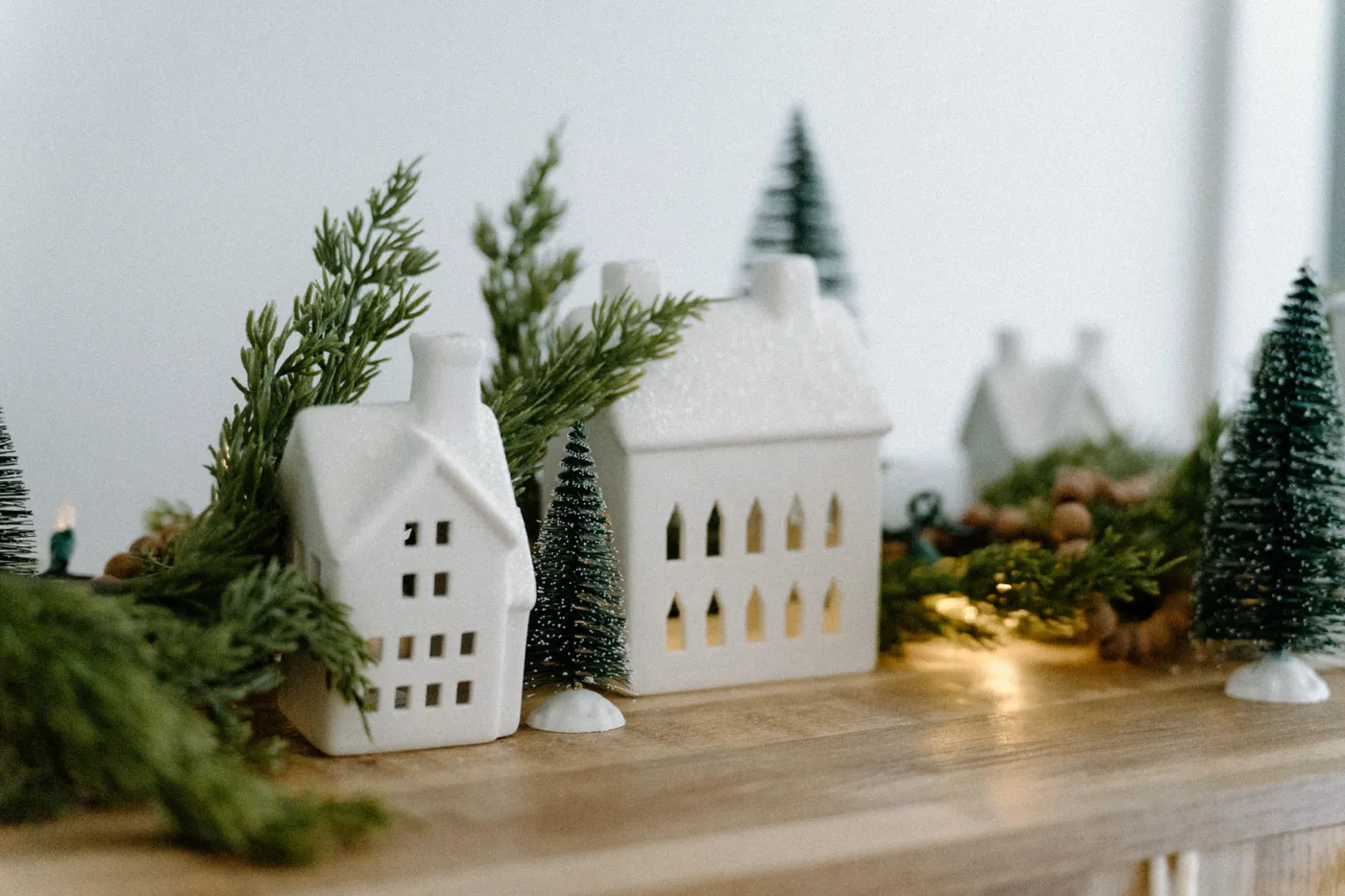 Charming Christmas village scene with decorative houses and festive trees, ideal for holiday ambiance.