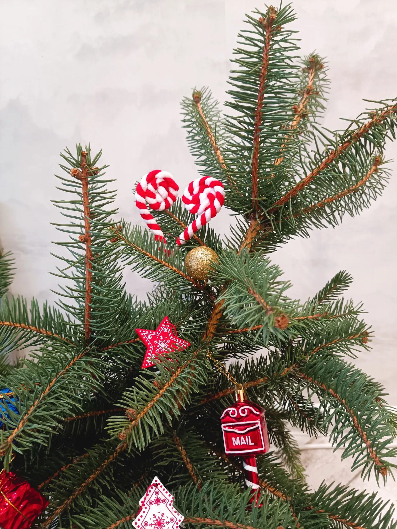 Close-up of a decorated Christmas tree with candy cane ornaments and festive decorations