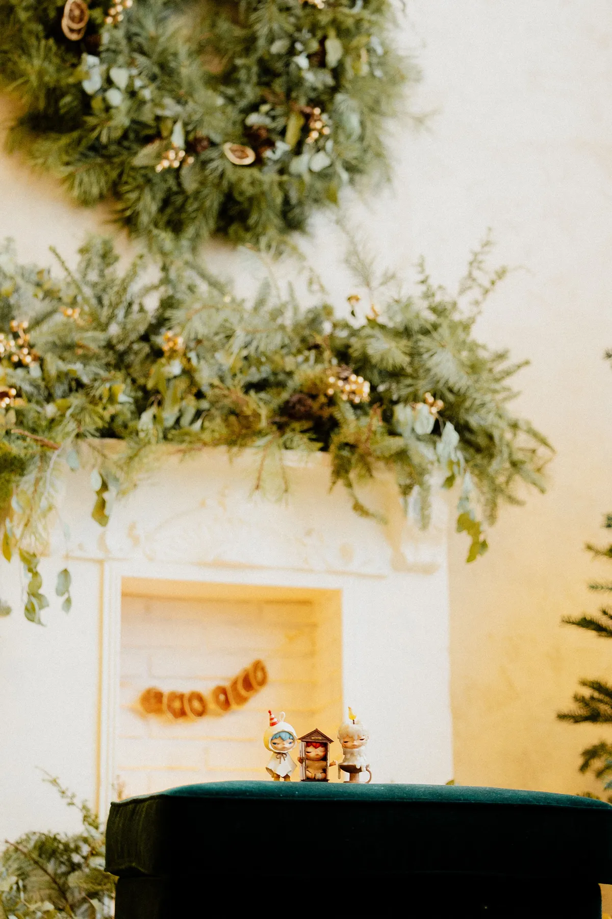 Cozy Christmas scene with wreaths and holiday figurines, perfect for festive ambiance.