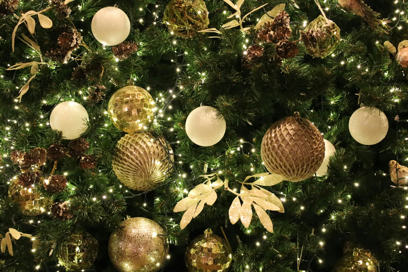 Decorated christmas tree with golden ornaments and lights