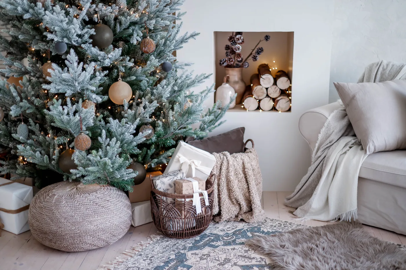 Elegant Christmas tree with rustic decor in a cozy living room setting.