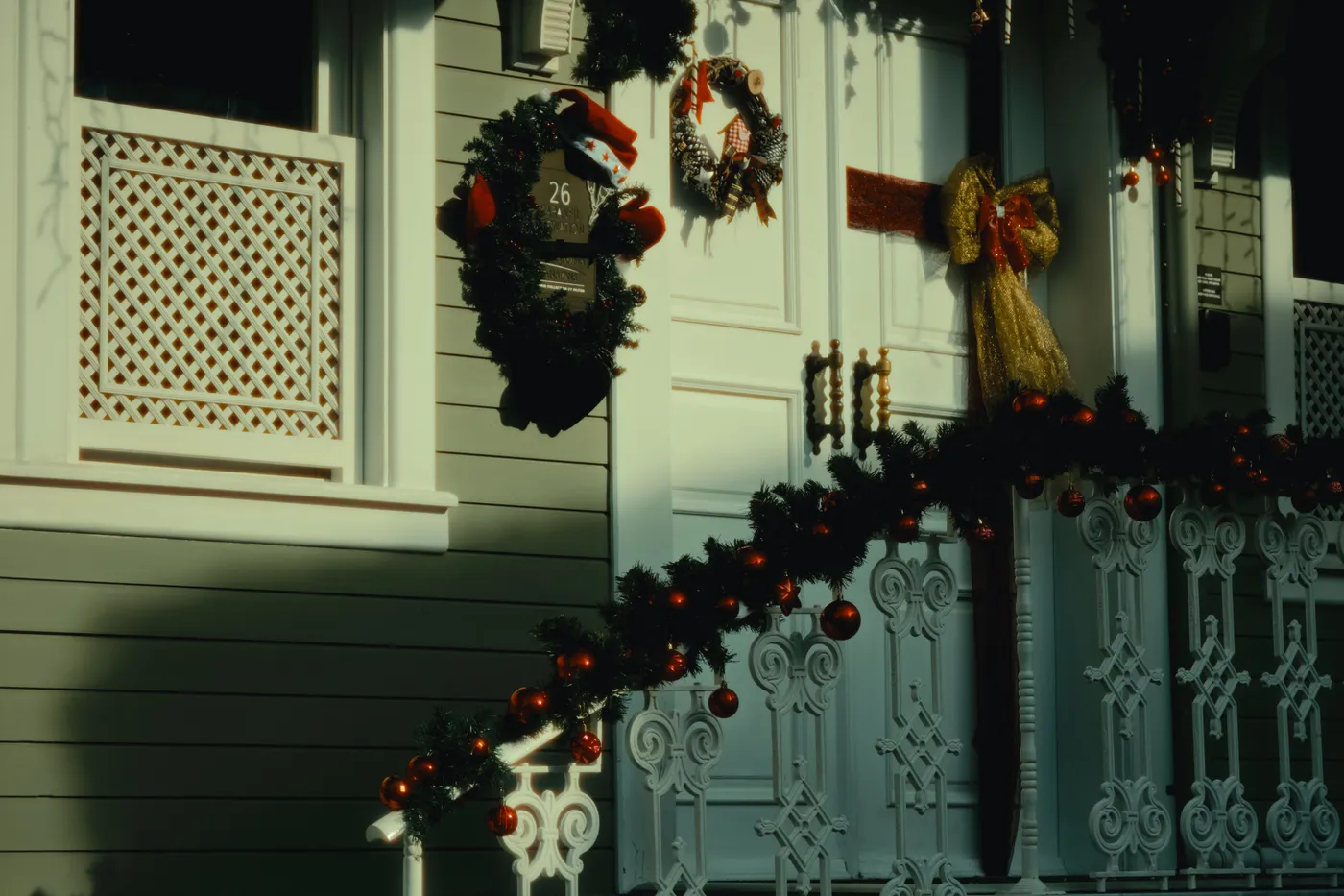 Elegant house adorned with festive Christmas wreaths and garlands, showcasing holiday spirit.