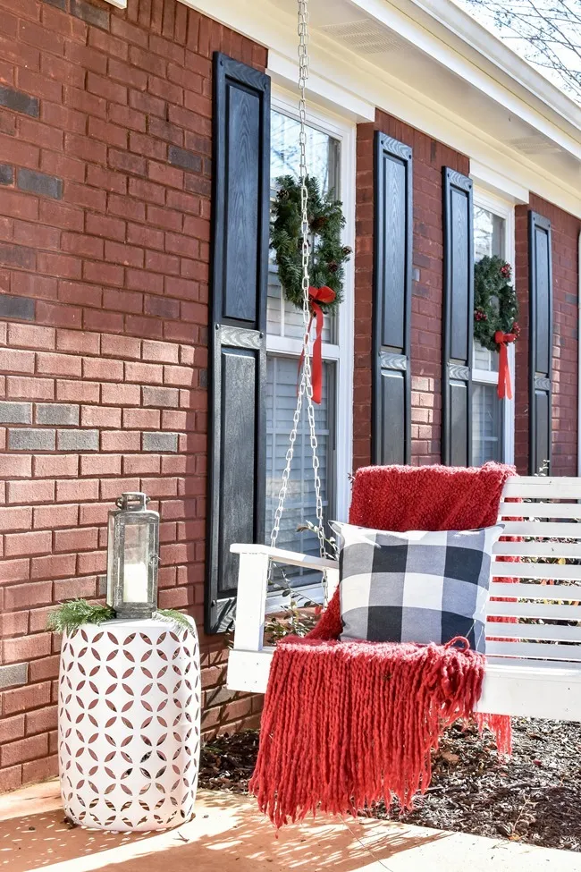 Farmhouse style Christmas front porch with picket fences
