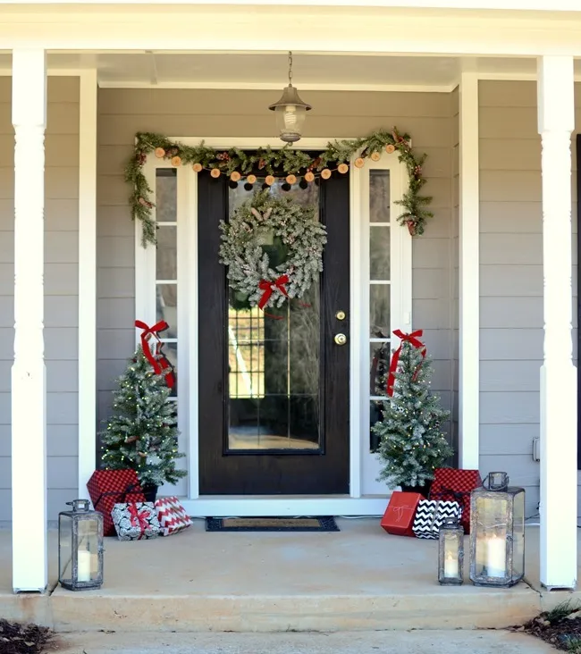 Farmhouse style Christmas front porch with picket fences