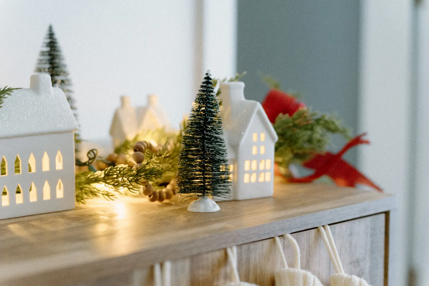Festive Christmas decor featuring ceramic houses and twinkling lights.
