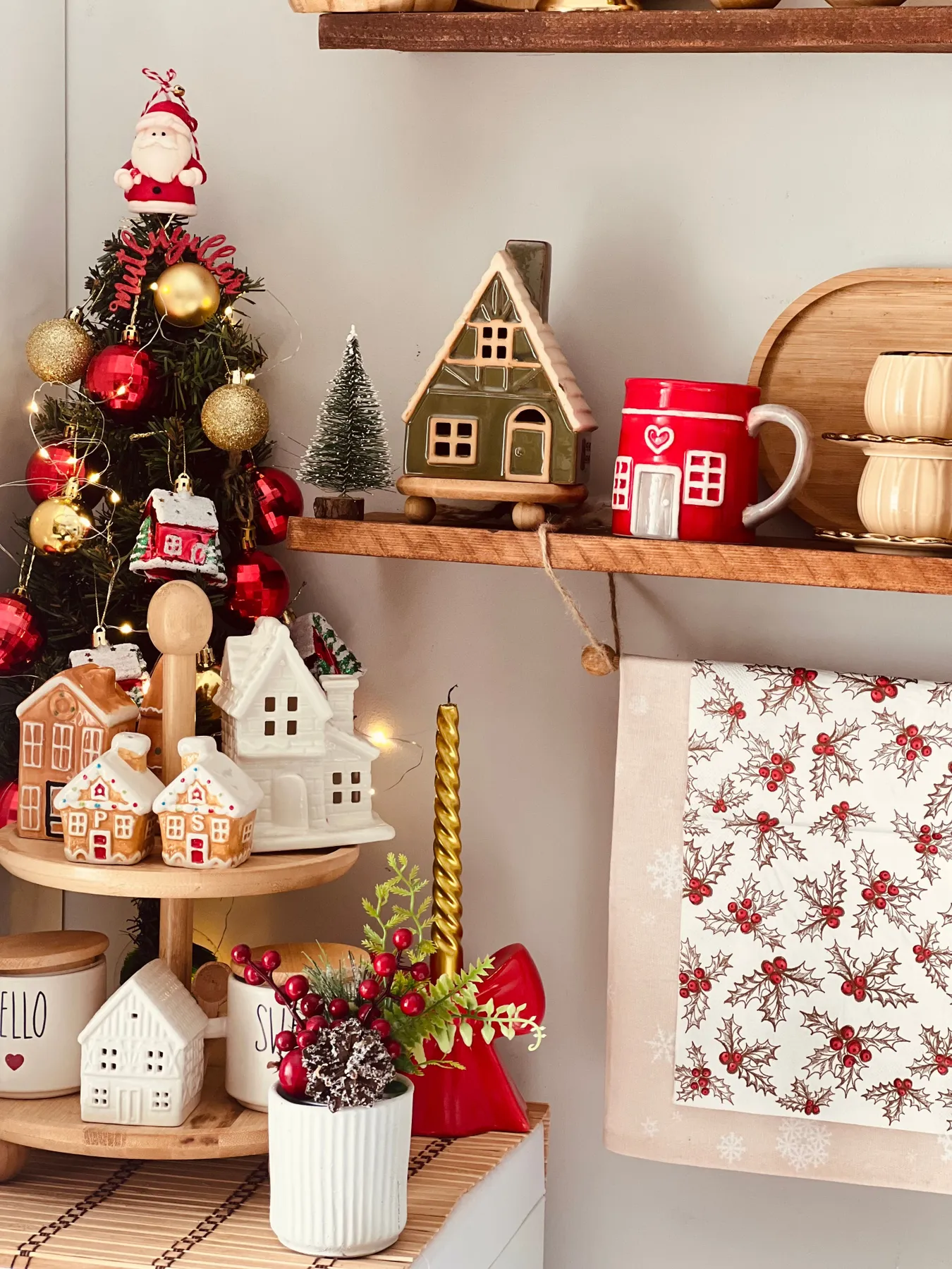 Festive kitchen scene with Christmas decor and gingerbread houses.