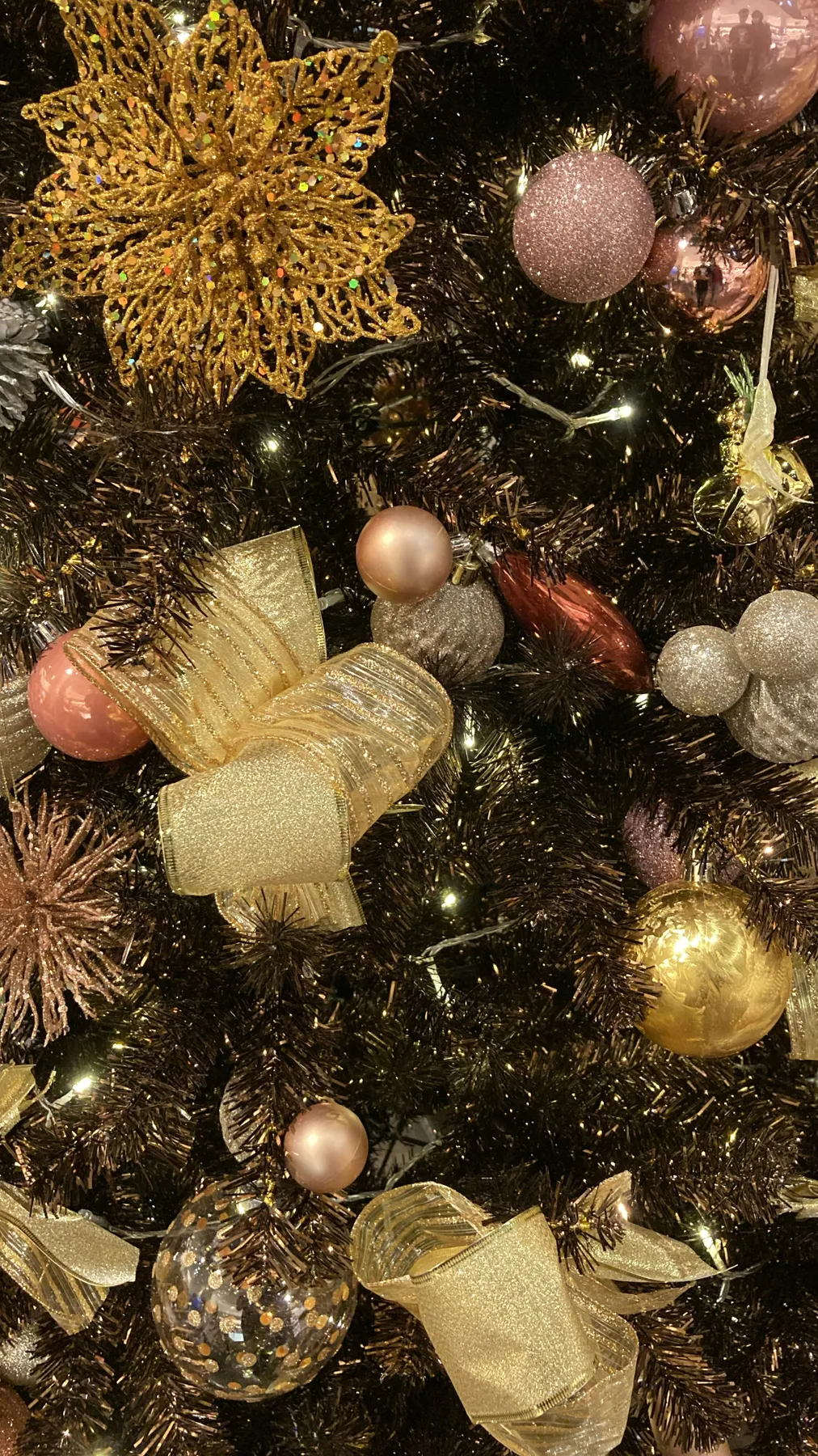 gold and silver baubles on green christmas tree