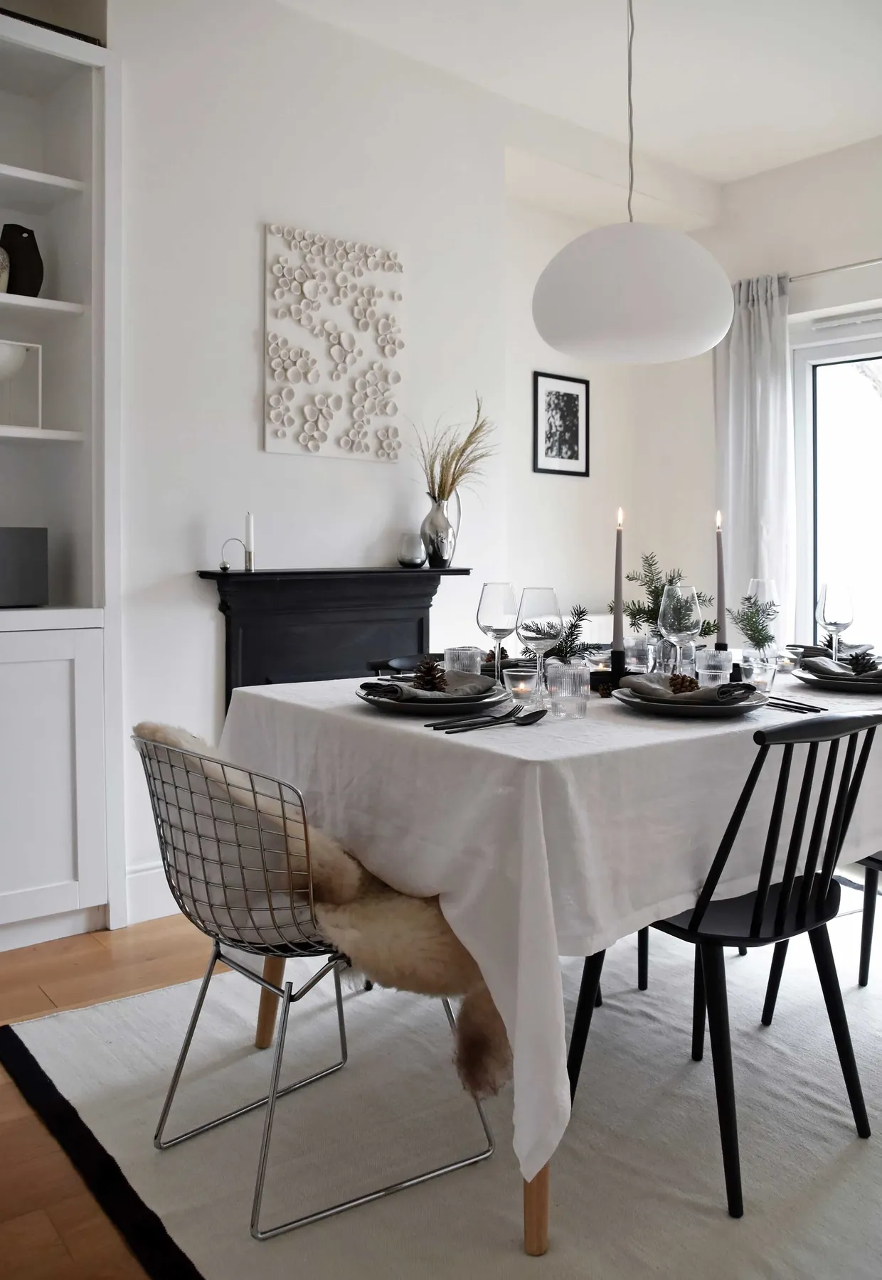 Minimalist Christmas table styling with fir, candles & pine cones |