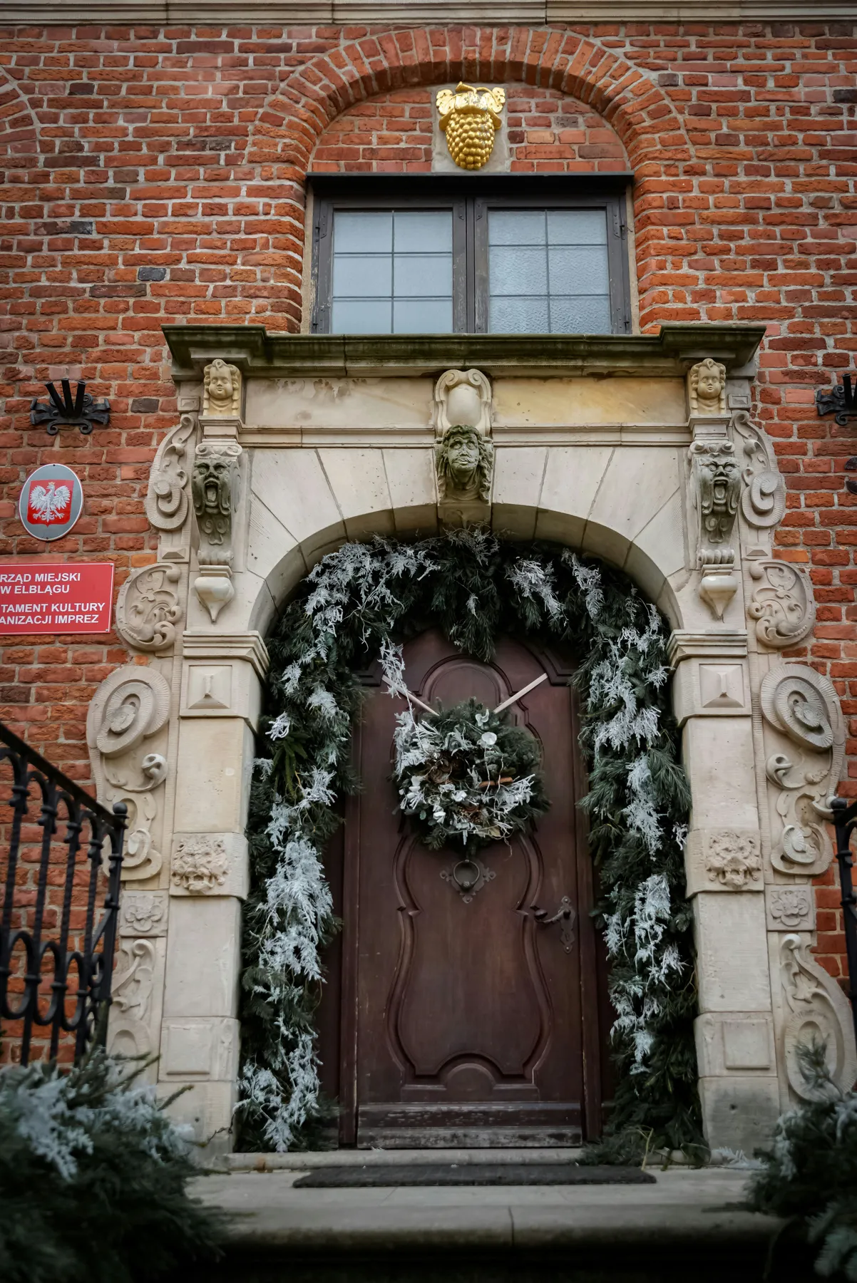 Ornate wooden door decorated for winter holidays
