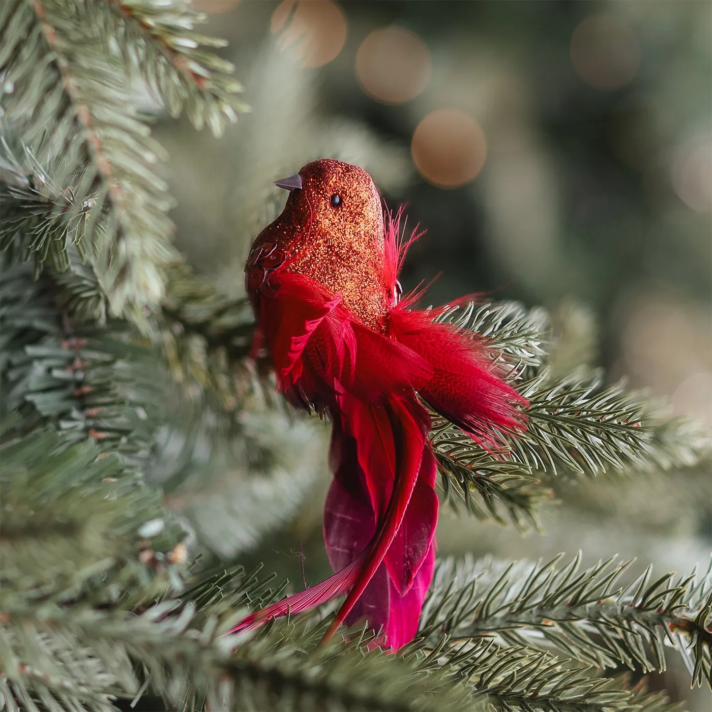 Red glitter clip-on bird with feather tail