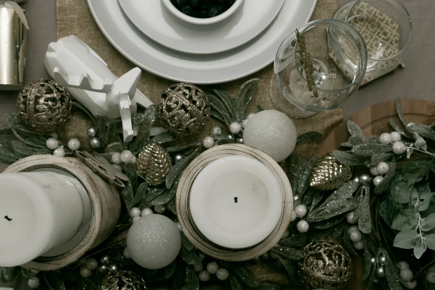 Top view of a festive Christmas table setup with elegant decorations and candles.