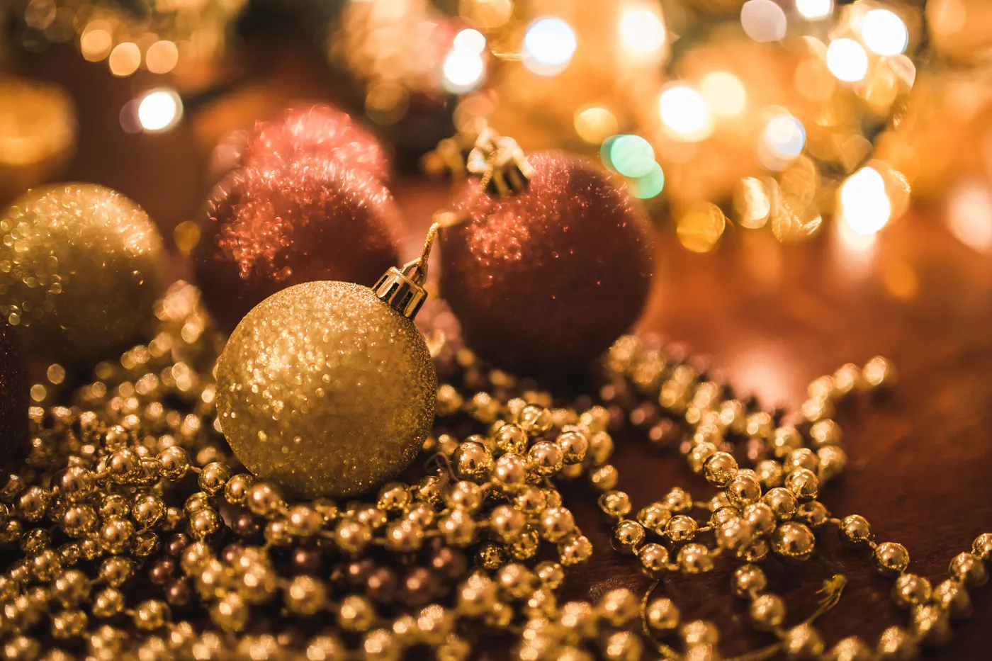 Warm holiday decorations with golden and red ornaments, perfect for festive celebrations.